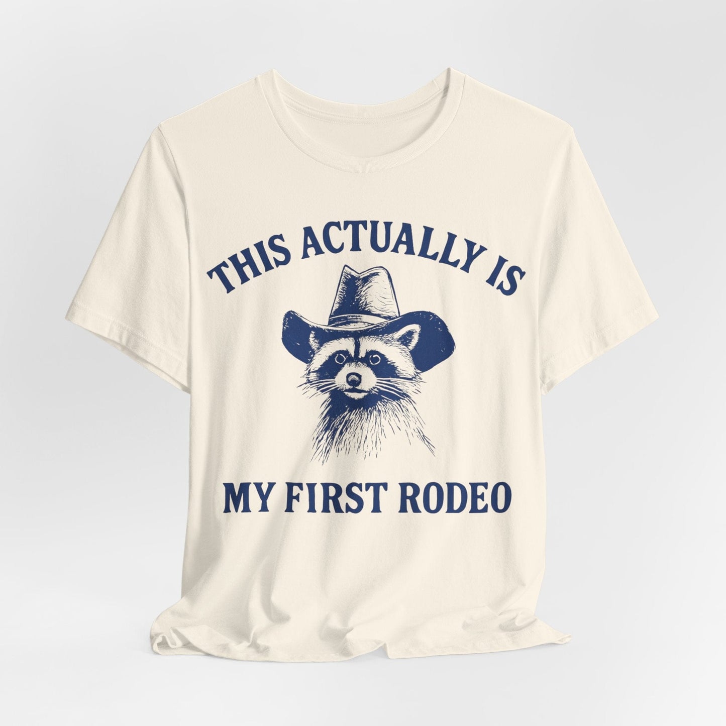 This Actually Is My First Rodeo – Cowboy Raccoon Tee