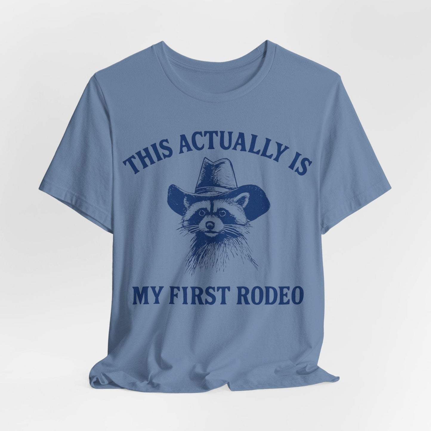 This Actually Is My First Rodeo – Cowboy Raccoon Tee