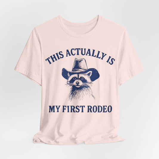 This Actually Is My First Rodeo – Cowboy Raccoon Tee