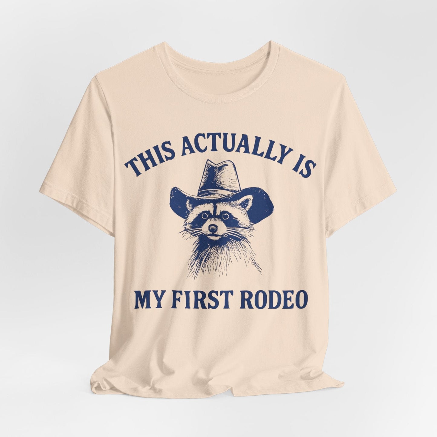 This Actually Is My First Rodeo – Cowboy Raccoon Tee