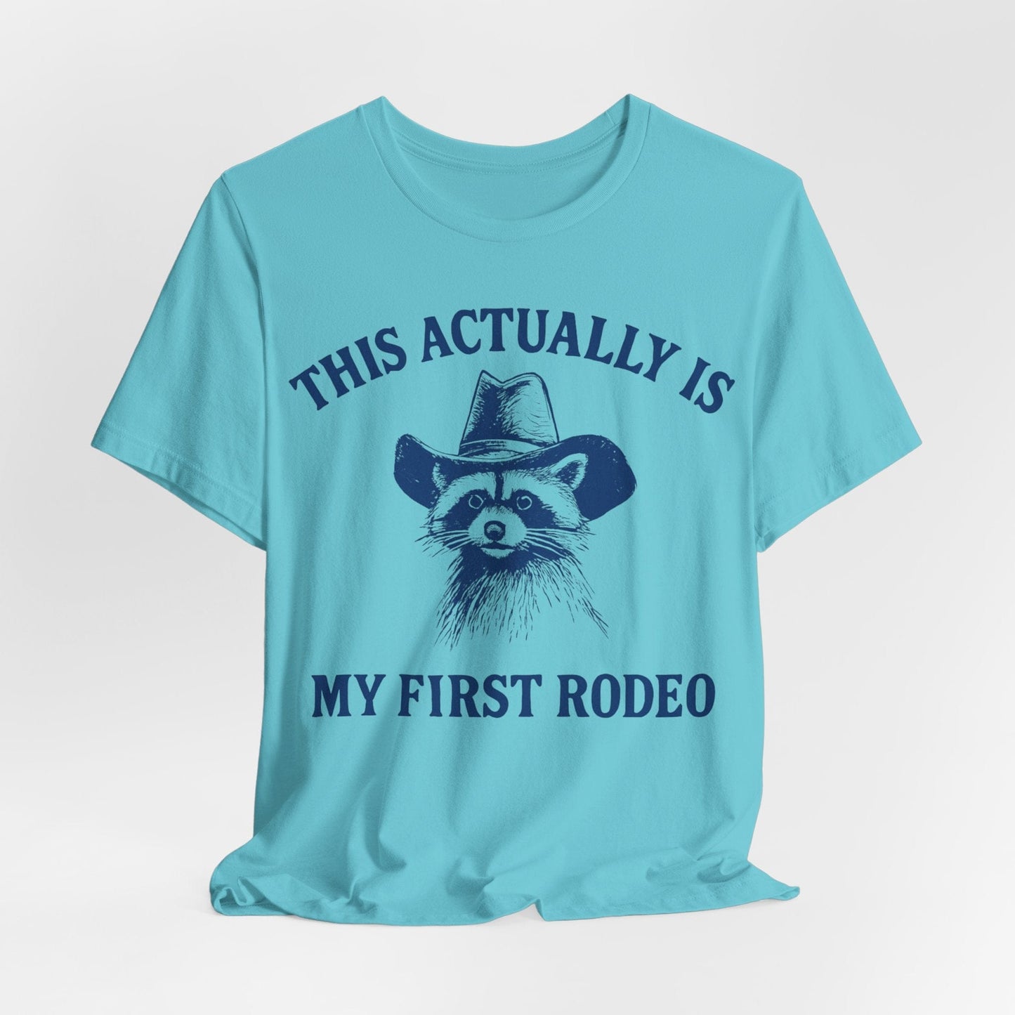 This Actually Is My First Rodeo – Cowboy Raccoon Tee